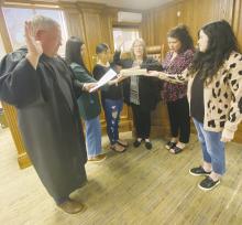 New Jack County Precinct 2 Commissioner Amy Salazar, center, is sworn in by County Judge Keith Umphress during the Monday, March 10 meeting. Salazar takes over for her husband, Kenny, who passed away last month. Photo/Brian Smith