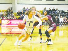 Bryson senior Allie Orr slips around defenders in a recent game. Orr had nine points and seven rebounds during the Cowgirls 51-24 victory Friday, Jan. 6 over Woodson. Photo/Brian Smith
