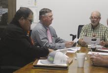 Jack County commissioners Kenny Salazar, Henry Birdwell and Gary Oliver look over the bills during the Monday, Nov. 26 meeting. Photo/Brian Smith