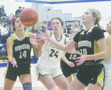 Perrin’s Kannan Collier (24) looks to grab the rebound between two Woodson defenders. Photo/Brian Smith