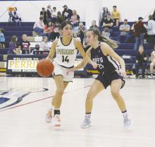 Perrin point guard Erika Hernandez looks to shed the Cross Plains defender during the Lady Pirates’ season opener Nov. 8. The visitors defeated Perrin, 82-25. Photo/Brian Smith