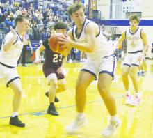 Ryan Richerson (33) hauls down a rebound. Perrin got out to a quick lead on Union Hill and posted an 87-48 victory on the area round of the playoffs. Photo/Brian Smith