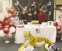 Jacksboro’s Kaleem Howard signed a national letter of intent to play football at Trinity University in San Antonio during a ceremony Friday, Dec. 8 at the Jacksboro High School library. With him are his parents and grandparents. A large crowd of supporters came out to witness the signing and take part in the event. Photo/Brian Smith