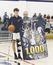 Last Friday was a special night for Perrin’s Jack McCormick and Kolby Burke. Burke, above, a senior, reached the 1,000-points in his high school career and was presented a poster by coach Todd McCormick. McCormick, below, a junior, reached the 2,500 point mark in his high school career. With him is his father and coach, Todd McCormick. Photo/Brian Smith