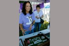 Jack County Clerk and Sesquicentennial time capsule volunteer Vanessa James shows items that survived from the Centennial time capsule buried at the county courthouse in 1975. No letters survived, but an urn vault was donated to secure items to be buried in December for the next 50 years. Photo/Ashley Anderson