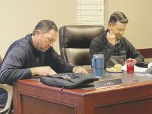 Perrin-Whitt CISD school board members James Hall, left, and Michael Francis look over paperwork during the Thursday, Dec. 19 board meeting. Photo/Brian Smith