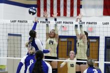 Baylee Meadows and Callie Weddle go up for a block against Garner. The Lady Pirates pulled off a complete game sweep against the Lady Longhorns in three sets. Photo/Ashley Anderson