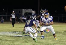 Ben Bennett runs with the ball past a Perrin-Whitt defender Friday, Oct. 17. The Cowboys narrowly lost 72-70 to the Pirates despite a monumental comeback effort. Photo/Ashley Anderson