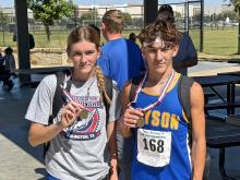 Joslyn Whitfill and Ty McComack pose with their medals Monday, Oct. 20 after competing in the 1A Region III Cross Country Championship in Grand Prairie. McComack and Whitfill both qualified for the state meet, with sixth and ninth place finishes, respectively. (Contributed photo/Bryson ISD)