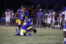 Canton Scobee prepares to kick a field goal lined up by Bryce Thorne. Scobee threw a touchdown pass in the game to Chris Rodriguez helping the team to a 52-6 win. Photo/Ashley Anderson