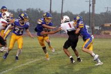 Canton Scobee runs away from defenders in the rain. The Scobee brothers were pivotal in the Cowboys win over Throckmorton. JHG file photo