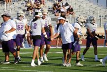 Casey Hubble talks to Tigers players on the sideline Thursday, Aug. 21. Hubble is the head coach of the Tigers varsity football team. Photo/Ashley Anderson