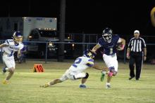 Cole Keeney runs up to stiff arm a Bryson defender Friday, Oct. 17. Keeney was pivotal in both the air and ground game to secure a Pirates victory in their homecoming game. Photo/Ashley Anderson