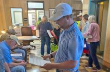 (Photo/Brian Smith) Tyler Harmonson looks over unofficial election results. Harmonson won the Place 5 alderman position.