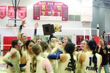 The Lady Pirates celebrate with their area championship trophy Tuesday, Nov. 4, after beating the Vernon Northside Lady Indians. The Lady Pirates won in a three set sweep by being prepared and focused, according to head coach Rebekah Bland. Alex Havardansky | The Graham Leader