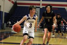 Tyler Roberts dribbles the ball to the outside during one of the Tigers’ tournament matches. The Tigers participated in the Red White and Blue Tournament in Graham from Thursday, Dec. 11 to Saturday, Dec. 13. Photo/Ashley Anderson