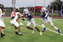 Issak Wesson, 2, and Garrison Johnson, run down field as Wesson carries the ball. The Tigers picked up their first win of the season over Burkburnett. Photo/Ashley Anderson