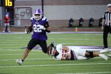 Issak Wesson catches a ball and runs out into the open field Friday, Sept. 19. The Tigers lost to the Indians 23-13 in this match. Photo/Ashley Anderson