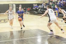 Braydee Thorne drives into the lane for Bryson during first quarter action against Archer City. Thorne had a pair of first quarter 3-pointers but the Cowgirls suffered a 40-19 loss to the Lady Cats. Photo/Brian Smith