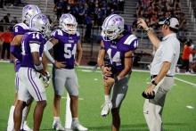 Members of the Tigers huddle on the sideline with the coaching staff in between possessions during a game. The Tigers will face Millsap Bulldogs in a district game Friday, Oct. 17.  Photo/Ashley Anderson