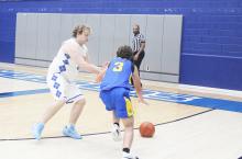 Jacob Hearne plays defense on the Sidney player heading to the basket. Hearne and his Bryson teammates are heading to the regional final after a 56-46 win over the Eagles. Photo/Brian Smith
