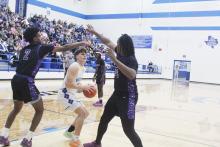Caleb Allen is blocked in by two Kennard defenders. Allen had 23 points in helping Bryson beat Kennard 59-55 and move into the Thursday, March 6 Class A Division 2 State Championship game against Jayton. Photo/Brian Smith