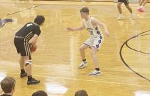 Gavin Guess plays defense Tuesday, Jan. 14 on the Woodson player during Bryson’s 50-38 win over Woodson. Photo/Brian Smith