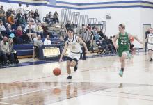 Jack McCormick drives inside for a basket for two of his 20 points. McCormick and the Pirates won their first district title in more than 60 years with a 79-31 win over Newcastle. Photo/Brian Smith
