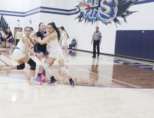 Baylee Meadows, left, and Lauren Morris play defense on the Garner player during Perrin’s regular season finale. Morris led the Lady Pirates with 18 points Tuesday, Feb. 4 in the 56-29 homecourt win. Photo/Brian Smith