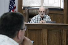 Jack County Commissioner Gary Oliver asks the sheriff’s office how its deputies process serve for the county. Commissioners voted to hire a part time deputy constable but Oliver voted against the measure twice. Photo/Ashley Anderson