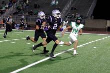 Issak Wesson runs away from a Valley View defender Friday, Oct. 31. Wesson had 80 receiving yards on the night with a touchdown in their dominant win 61-0. Photo/Ashley Anderson 