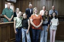 Jack County officials proclaim the first full week of October as National 4-H week. Local 4-H Club members tell commissioners Monday, Sept. 22 about their favorite club activities as well as what they’ve learned since signing up. Pictured bottom from left is Maddison Brasket, Savannah Brooks, Morgan Ellis, Allie Hamilton and Kenadee Sell, and top from left are Commissioners Gary Oliver and Amy Salazar, Judge Keith Umphress, and Commissioners Henry Birdwell, Jr. and Terry Ward. Photo/Ashley Anderson