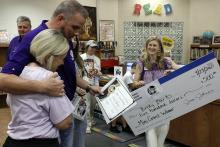 Jacksboro Elementary School library paraprofessional Becky Burks, left, accepts $500 to purchase Wonderbooks, along with foundation VP of Programs Jon Mathis and Executive Director Kelly Castle. Jacksboro Education Foundation surprised seven Jacksboro ISD teachers with mini grants to help purchase supplies and resources for their classrooms. Photo/Ashley Anderson
