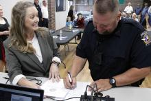 Jacksboro City Secretary Shalyn Burritt collects Officer James Henry’s official signature as he rejoins the Jacksboro Police Department Monday, Aug. 25. Photo/Ashley Anderson