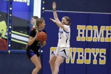 Lyssa Newton plays man defense in one of the Cowgirls’ previous matchups. The Cowgirls fought hard but lost Monday, Nov. 24 against the Vernon Lady Lions.  Photo/Ashley Anderson