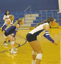 Left to right, Johanna Herpeche, Braydee Thorne, and Jaydah Mc- Comack ready themselves for the Santo serve during Bryson’s home opener Tuesday, Sept. 3. The Cowgirls swept past the Lady ‘Cats in three games.
