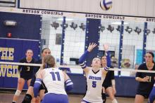 Ellys Behling, 5, and McKinlea Brasket, 11, set up on the offense for a pass Tuesday, Oct. 7. The Cowgirls picked up a dominant set one win and played hard in their loss to the Lady Pirates. Photo/Ashley Anderson