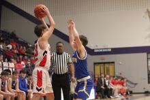 Bryce Thorne plays up on defense Monday, Feb. 23 against the Midway Falcons. The Cowboys fought hard but lost in bi-district play 53-34. Photo/Alex Havardansky