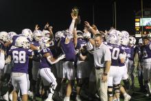 The Tigers celebrate with their Bi-District Championship trophy Thursday, Nov. 13 after defeating the Tolar Rattlers 41-20. Head coach Casey Hubble said he is proud of how the team responded to adversity this season to pick up the victory. Photo/Alex Havardansky