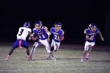 Canton Scobee runs with his blockers for the Bryson Cowboys offense Thursday, Oct. 23 against the Knox City Greyhounds. Bryson utilizes a heavy run game to set the tone in their competitions. Photo/Ashley Anderson