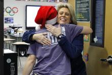 Jacksboro social studies teacher Elaine Jorgenson shares a hug with Jacksboro Education Foundation VP of Programs Mallory Tolleson on Foundation Friday. JEF delivers goodies once a month to teachers and staff who elected to donate a portion of their paycheck to the foundation. Photo/Ashley Anderson