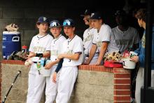 Pirates hang outside the dugout before a home game in April. Perrin-Whitt advances in the postseason after one of the program’s most successful seasons. Photo/Ashley Anderson