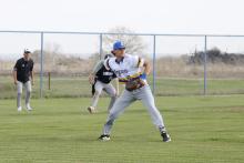 Caleb Allen looks for the play on an infield grounder Tuesday, March 10. The Cowboys fought hard but lost to Lindsay 14-5. Photo/Ashley Anderson