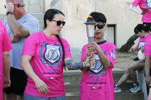 Special Olympics athletes carry the Flame of Hope in the Law Enforcement Torch Run in Jack County, raising funds to send local athletes to summer games. Photo/Ashley Anderson