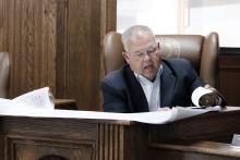 Jack County Judge Keith Umphress reviews plans Monday, March 23 for Stone Oak Preserve subdivision located three miles east of Newport on FM 2127. Commissioners approved the development of the subdivision in Precinct 1. Photo/Ashley Anderson