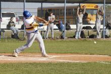 Ben Bennett makes contact at the plate Tuesday, March 24 against the Bellevue Eagles. Bennett scored one run and sent another runner home in the Cowboys’ 12-1 win. Photo/Ashley Anderson