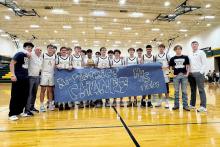 The Perrin-Whitt Pirates pose with their Bi-District champs trophy and banner Tuesday, Feb. 24 after defeating the Forrestburg Longhorns. The Pirates played a complete team game and came away with a dominant 84-38 victory. Contributed photo