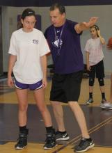 Jacksboro Girls Basketball Coach Todd Matlock works with a camper during basketball volleyball camp Monday morning