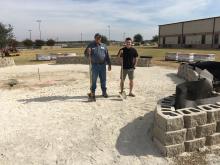 Greg Lewis, owner of GAL Horticultural Services, and Texas FFA Ford Leadership Scholar, Hunter Hackley, inspect construction of the JHS Memorial Courtyard.  