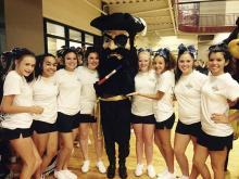 Perrin High School varsity cheerleaders and mascot Petey the Pirate pose for a picture while at cheer camp recently.